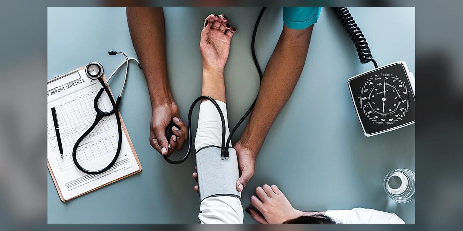 A healthcare professional performing blood pressure monitoring on a patient.